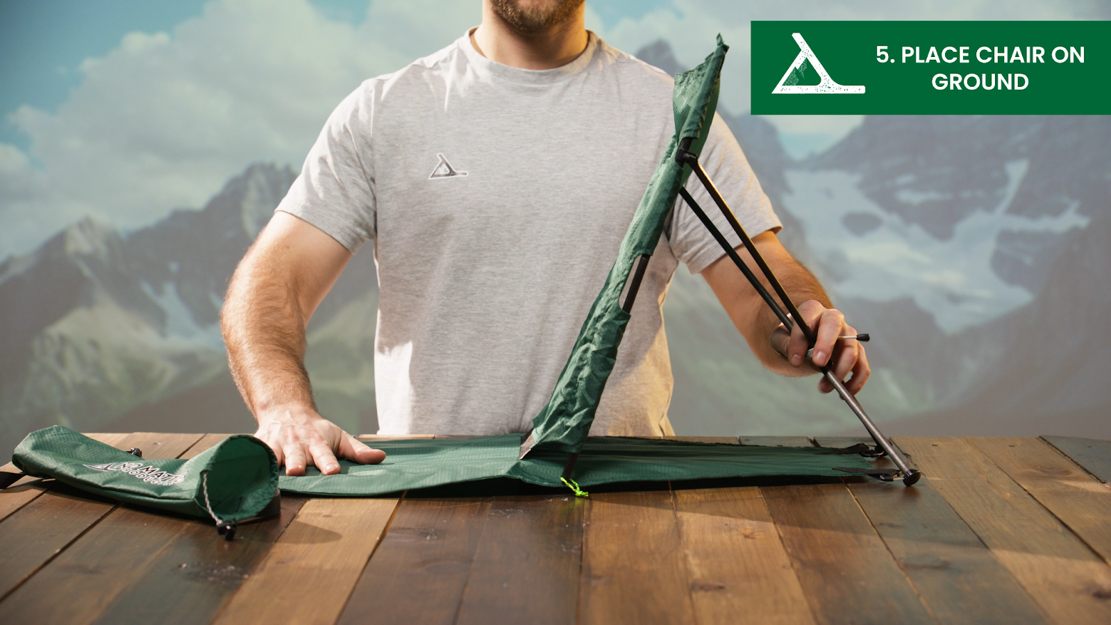 Man demonstrating how to set up a foldable green chair during a product explainer video shoot.
