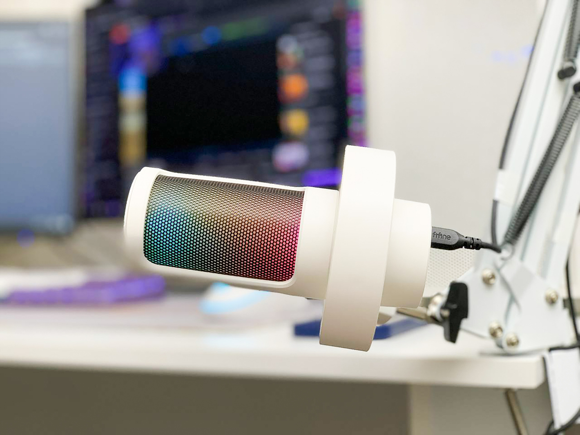 Professional microphone for explainer video production voiceovers with editing software in background