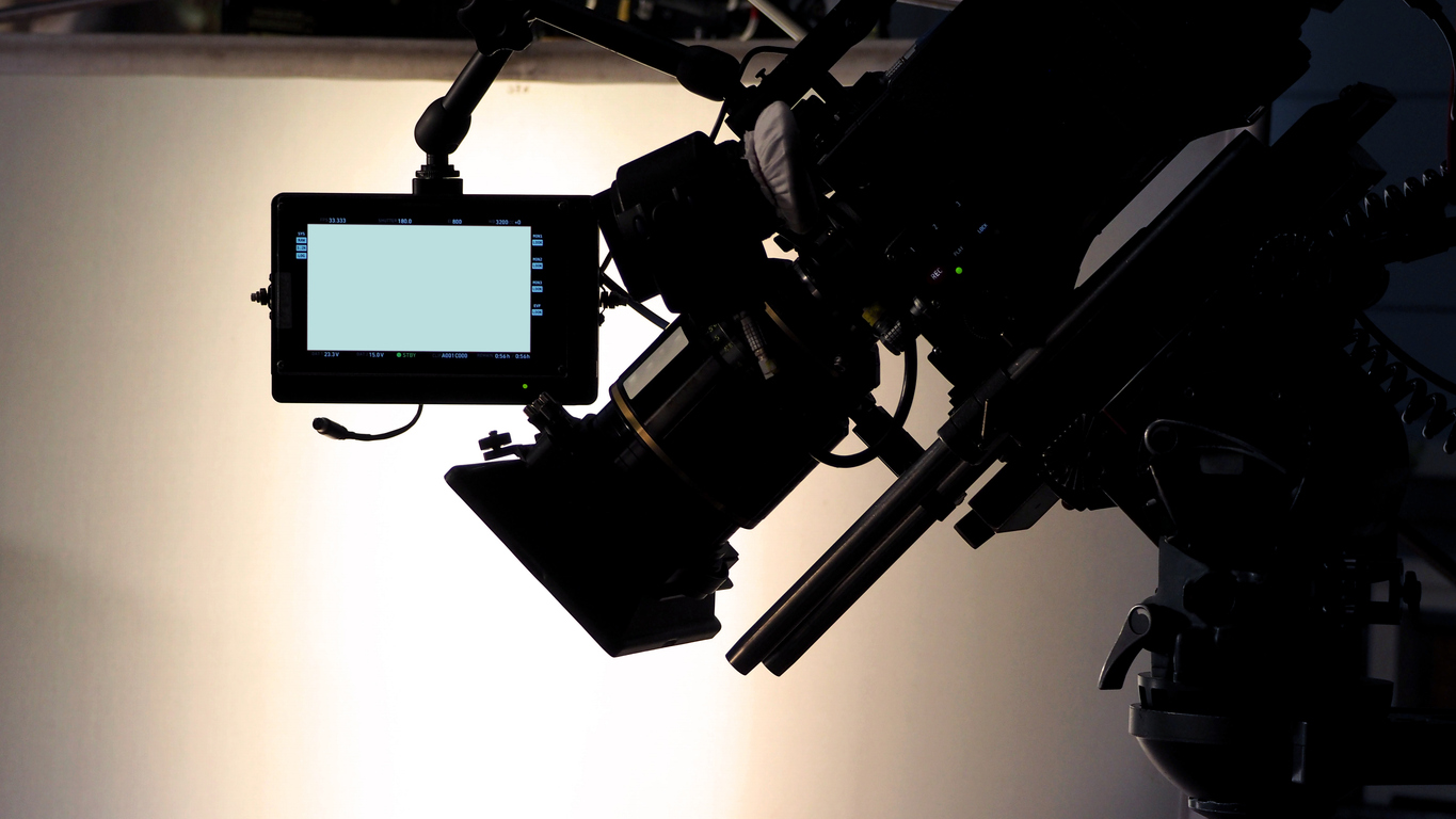 Professional camera equipment silhouette for simplified video production on a budget