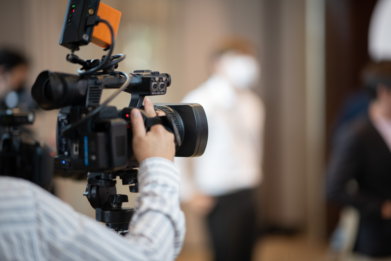 Professional videographer operating a high-end camera during a motion graphics production shoot