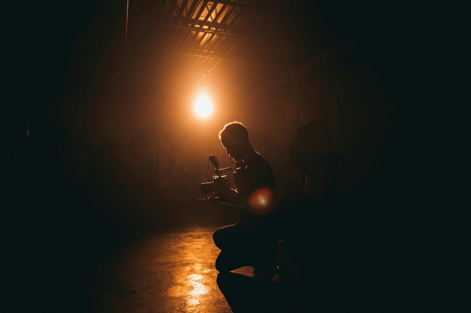 Cinematographer capturing visual storytelling through strategic lighting and camera positioning