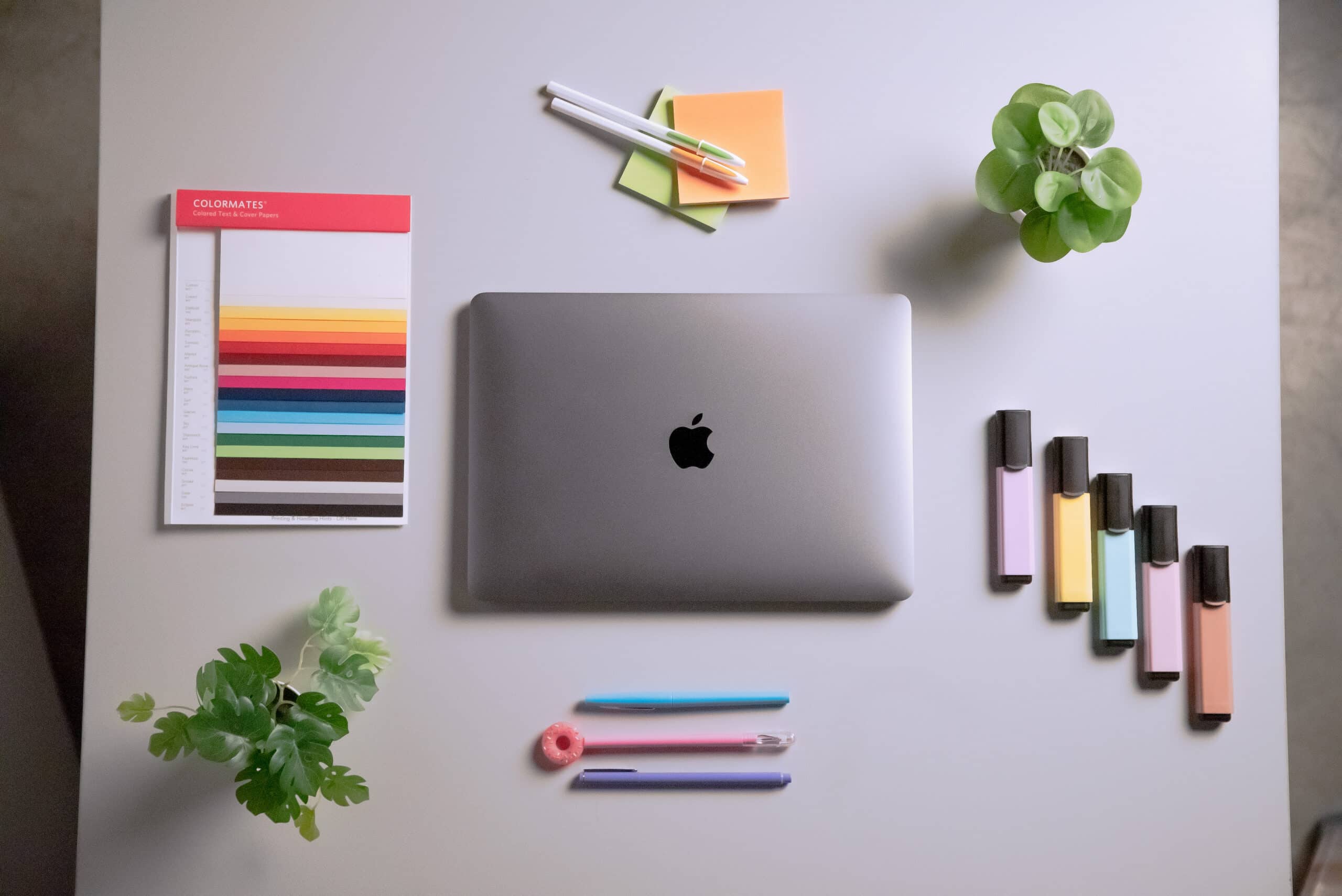 Organized flat lay of creative tools and a laptop, symbolizing Backflip’s digital marketing, content strategy, and brand development services
