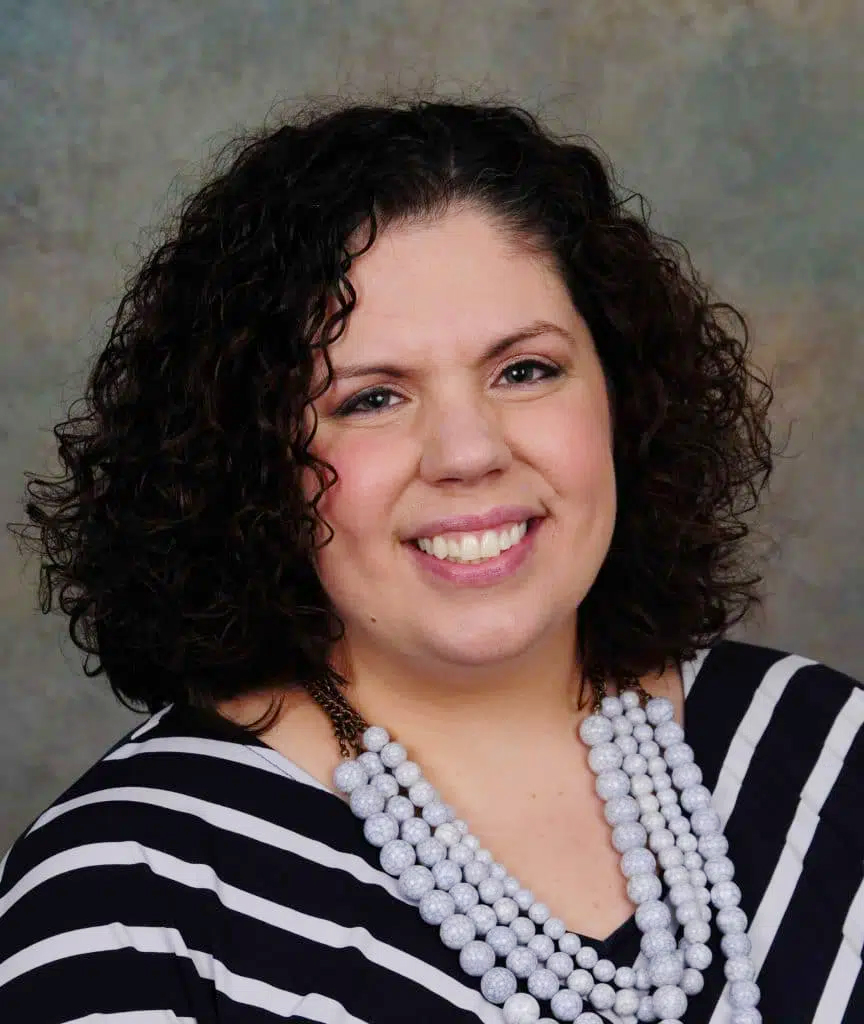 Carolyn Averill, Advancement Director, smiles in a professional headshot after giving a 5-star review of Backflip’s Christian video production services
