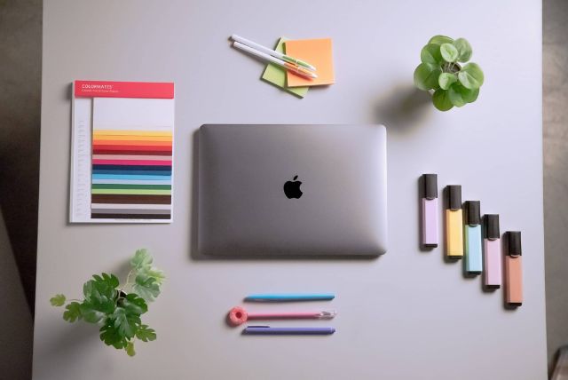 Organized flat lay of creative tools and a laptop, symbolizing Backflip’s digital marketing, content strategy, and brand development services