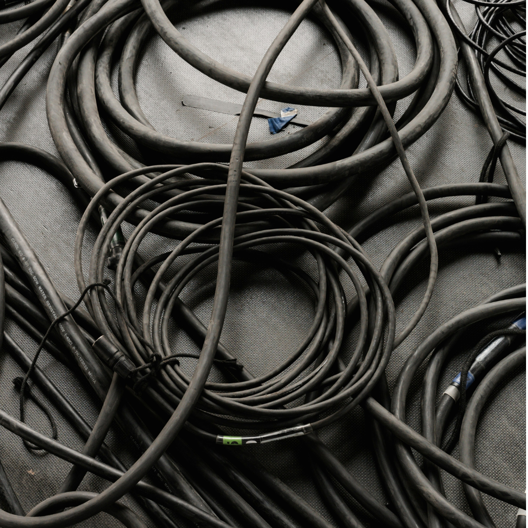 A pile of cables and adapters cleanly wrapped and ready for use.